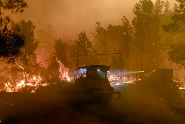 Firefighting bulldozers in the community of Cohasset near Chico