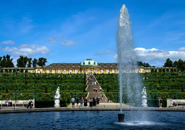 A fountain sprays water at the bottom of the Sanssouci Palace 