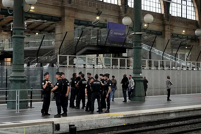 Police officers patrol inside the Gare du Nord train station at the 2024 Summer Olympics