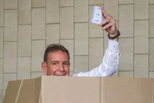 The opposition’s presidential candidate Edmundo Gonzalez shows his ballot as he votes in the presidential election in Caracas 