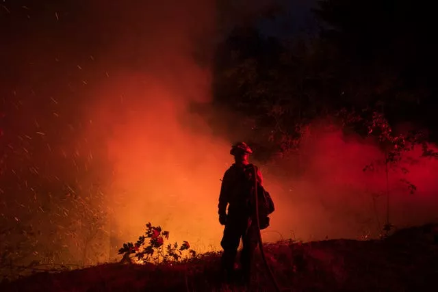 A firefighter from the city of Monterey monitors flareups from the Park Fire