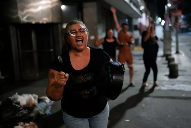 Supporters of opposition candidate Edmundo Gonzalez bang pots after the polls closed for the presidential election in Caracas