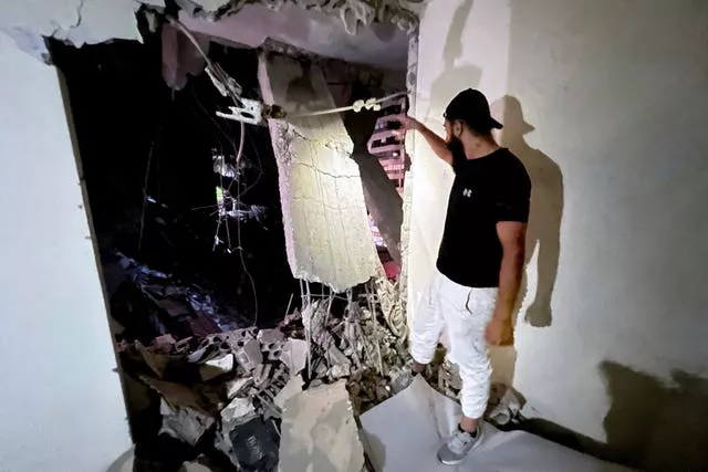 A man inspects a destroyed building that was hit by an Israeli airstrike in the southern suburbs of Beirut, Lebanon