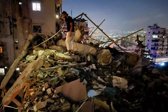 A man inspects a destroyed building that was hit by an Israeli airstrike in the southern suburbs of Beirut, Lebanon