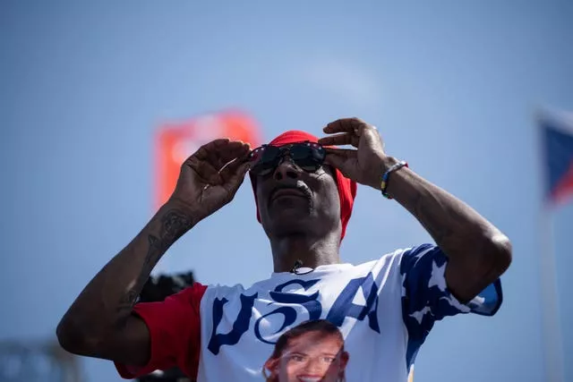 A man with red cap and sunglasses and USA T-shirt