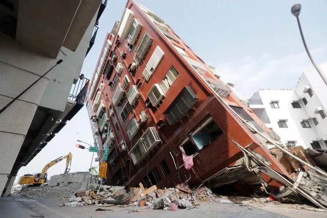 Debris surrounds a tilted building a day after a powerful earthquake struck, in Hualien City, eastern Taiwan 