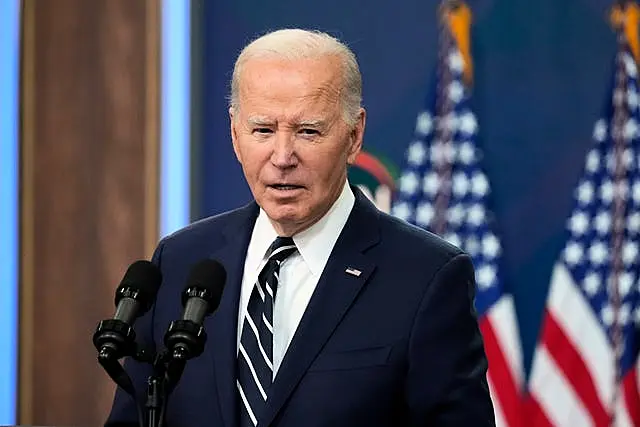 President Joe Biden speaking in front of an American flag