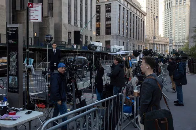 Members of the media gather outside Manhattan Criminal Court in New York