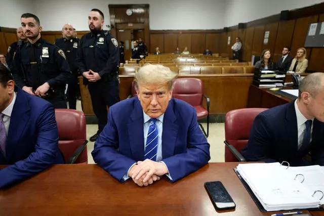 Former US president Donald Trump awaits the start of proceedings on the second day of jury selection at Manhattan Criminal Court in New York 