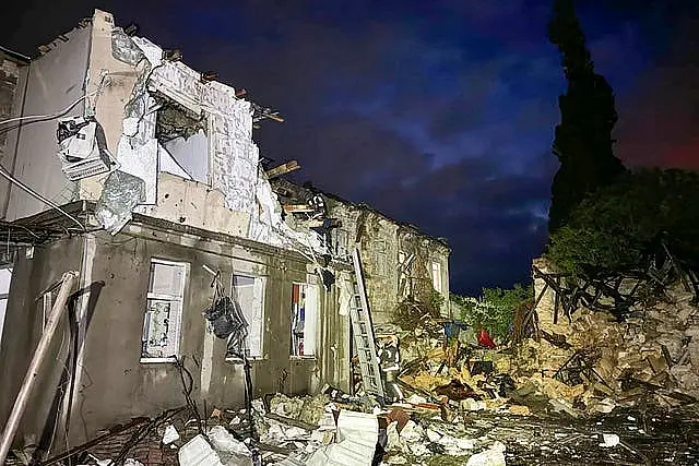 Firefighters work on the site of a damaged building after a Russian drone attack in Odesa, Ukraine