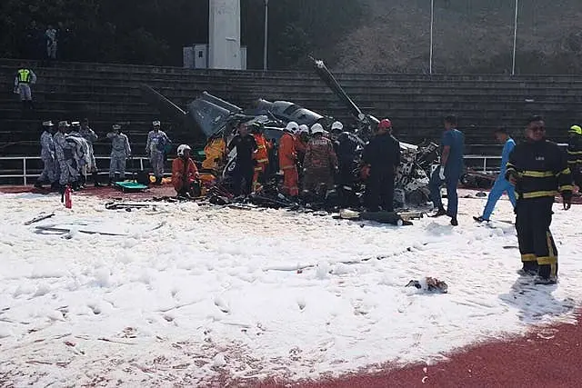 Fire and rescue workers inspect the crash site 