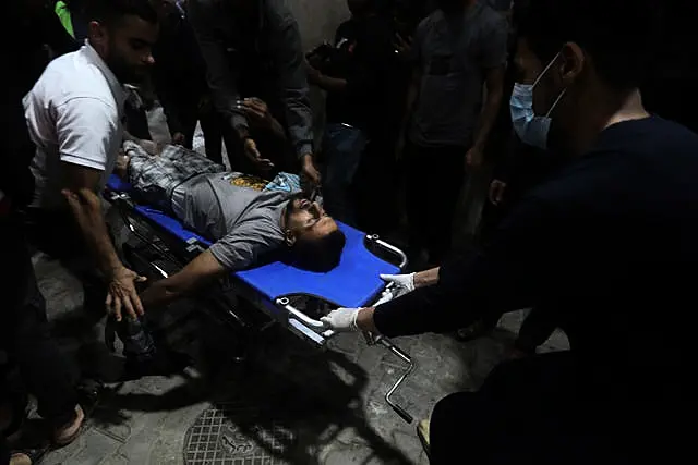 An injured Palestinian is brought to the Kuwaiti Hospital in Rafah refugee camp