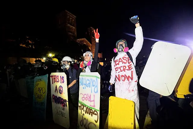 Demonstrators with makeshift shields