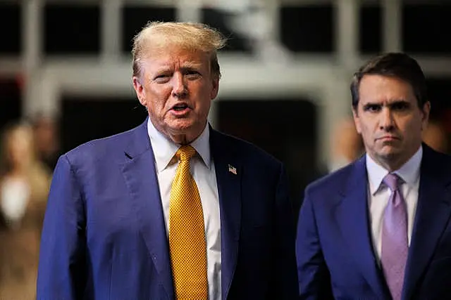 Former President Donald Trump, with his attorney Todd Blanche, speaks to reporters following the day’s proceedings in his trial 