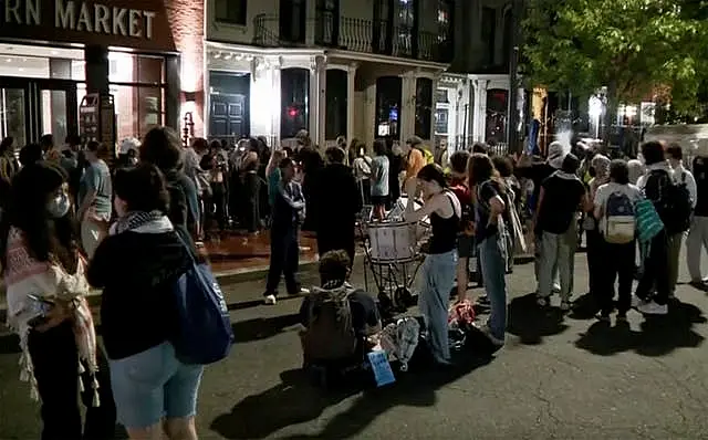 In this grab taken from video, protesters protesting the Israel-Hamas war stand outside near the campus of George Washington University, in Washington 