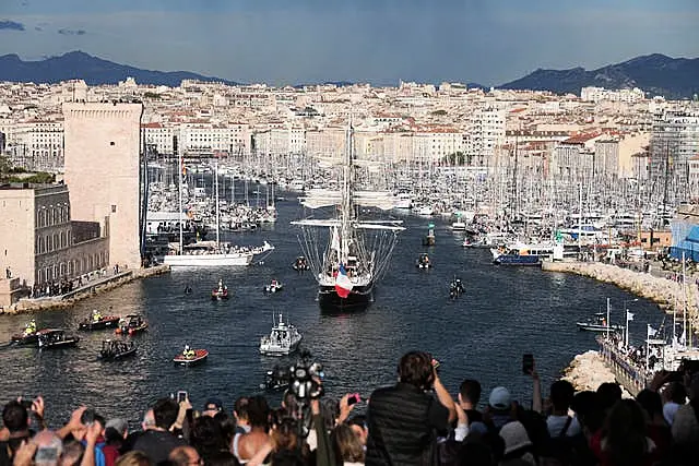 Multidões assistem enquanto o Belém, o veleiro de três mastros que traz a chama olímpica da Grécia, entra no Porto Velho de Marselha, no sul da França