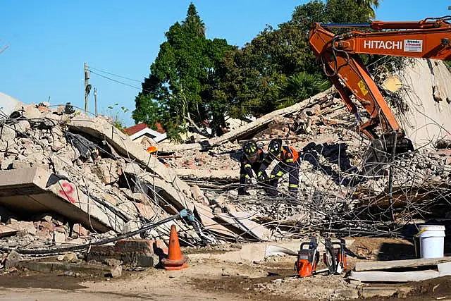 Rescue personnel search the site of a building collapse in George, South Africa