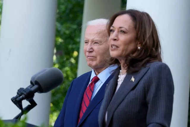 President Joe Biden listens as Vice President Kamala Harris speaks in the Rose Garden of the White House in Washington