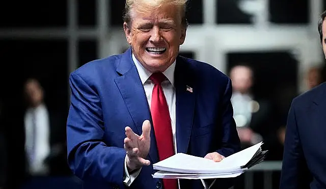 Donald Trump speaks to the press before leaving for the day at his trial at Manhattan Criminal Court in New York on Friday 