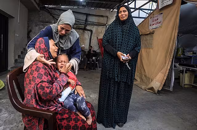 Palestinians mourn their relatives at a hospital in Rafah, Gaza