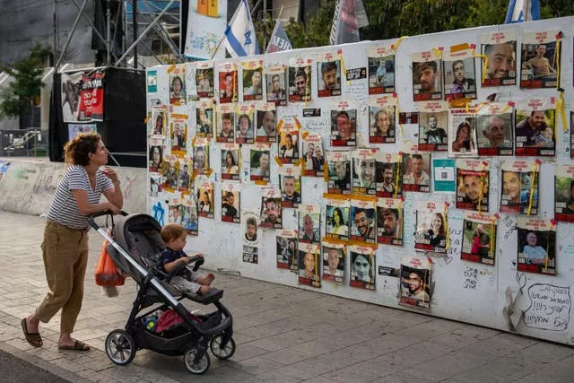 Photos of hostages held in the Gaza Strip on a wall in Tel Aviv, Israel 