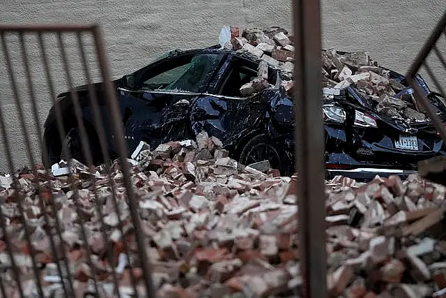 A car damaged by fallen bricks