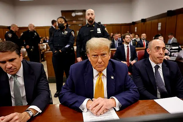 Former US president Donald Trump sits in the courtroom with lawyers Todd Blanche, left, and Emil Bove at Manhattan Criminal Court before his trial in New York