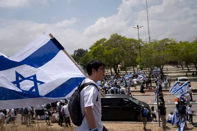 Thousands of Israelis march with national flags in the southern city of Sderot calling for Israel to reoccupy the Gaza Strip once the war is over 