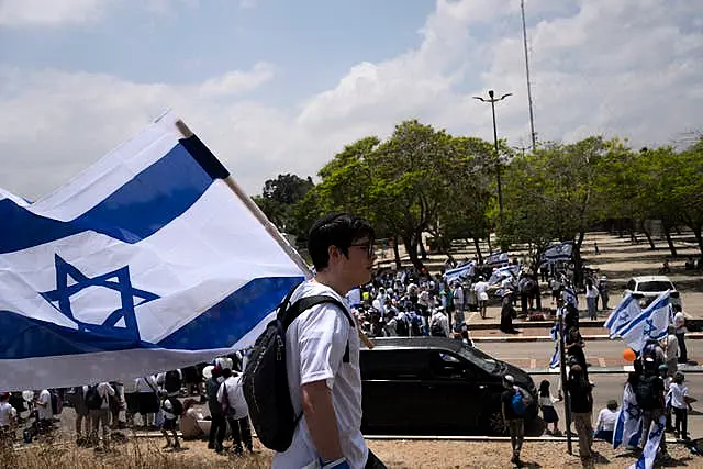 Thousands of Israelis march with national flags in the southern city of Sderot calling for Israel to reoccupy the Gaza Strip once the war is over 