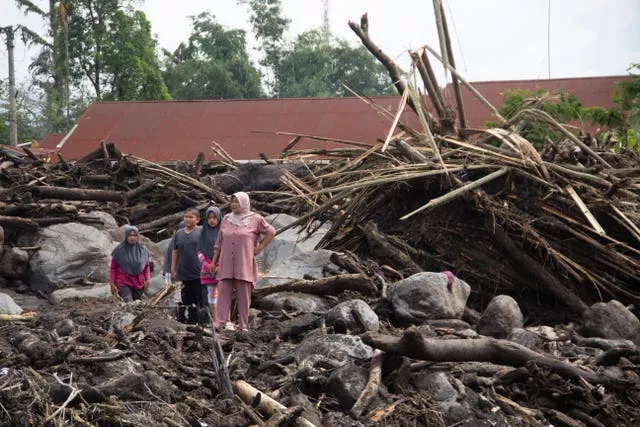 People inspect the damage by a flash flood in Agam, West Sumatra, Indonesia 