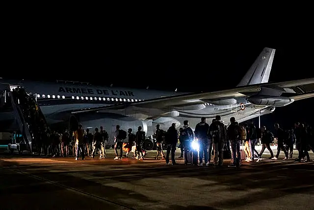 Security forces boarding a plane to New Caledonia 