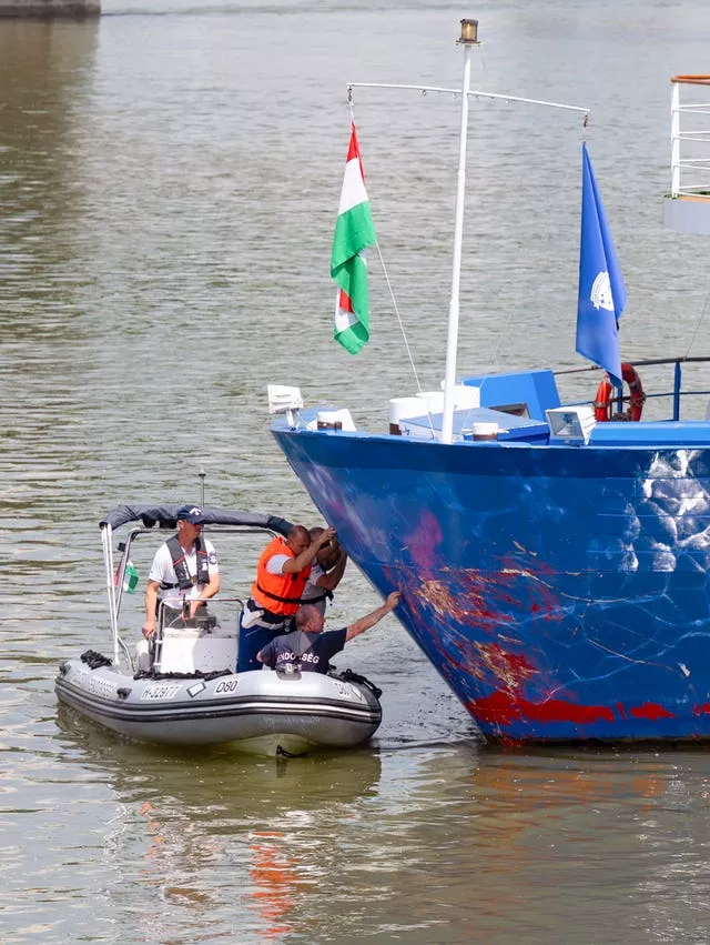 Police investigators examine the bow of a river cruise ship after an incident, in Komarom, Hungary 