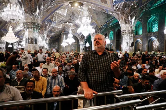Iranian pilgrims pray for President Ebrahim Raisi at Imam Reza Shrine in the city of Mashhad