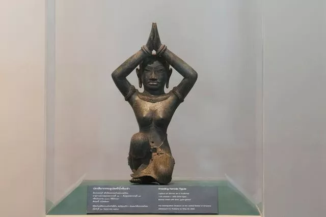 The ancient bronze kneeling woman sculpture is displayed during a repatriation ceremony at National Museum in Bangkok, Thailand