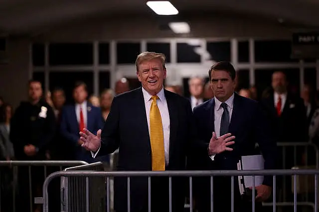 Former US president Donald Trump speaks to reporters alongside his lawyer Todd Blanche at Manhattan Criminal Court in New York