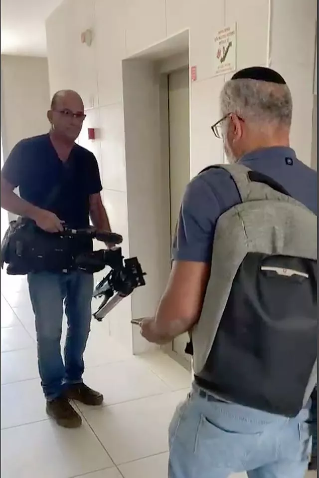 In this image from video, Israeli officials seize AP video equipment from an apartment block in Sderot, southern Israel