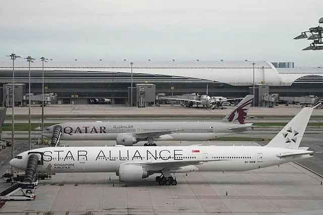 The Boeing 777-300ER aircraft of Singapore Airlines, front, is parked after the SQ321 London-Singapore flight, that encountered severe turbulence, at Suvarnabhumi International Airport, near Bangkok, Thailand 