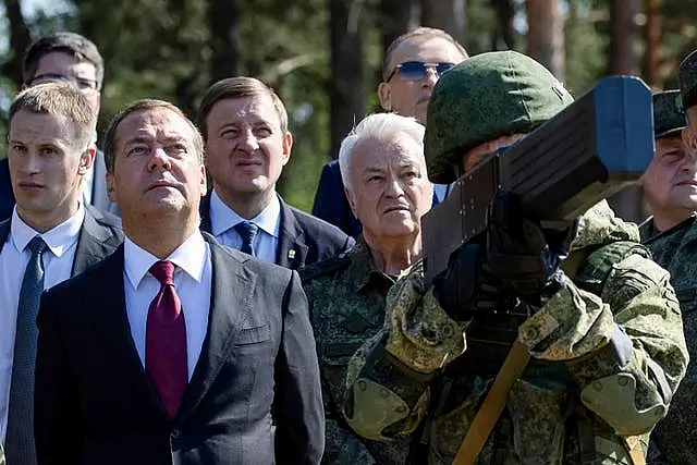 Dmitry Medvedev watches an anti-drone rifle demonstration