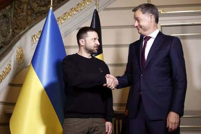 Volodymyr Zelensky, left, shakes hands with Belgium’s Alexander De Croo