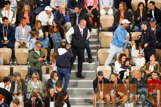 Iga Swiatek, bottom row fourth from left, Carlos Alcaraz, top row third from left, and Novak Djokovic, standing right in blue sweater and white cap, were all in attendance