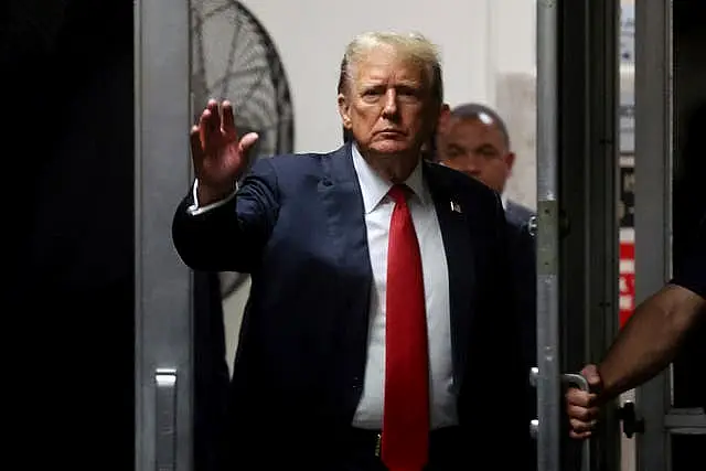 Former US president Donald Trump arrives after a lunch break during closing arguments in his criminal hush money trial at Manhattan Criminal Court in New York 