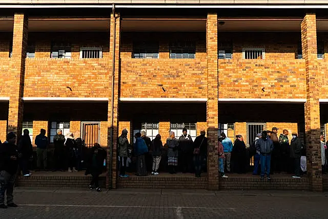 Voters line up to cast their ballot in general elections in Soweto, South Africa