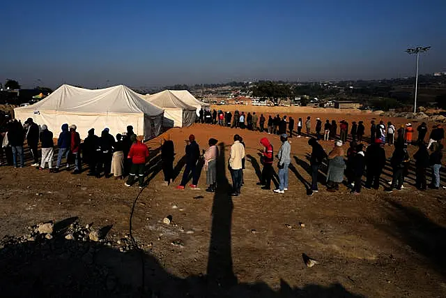 Voters line up to cast their ballot for general elections in Alexandra, near Johannesburg, South Africa