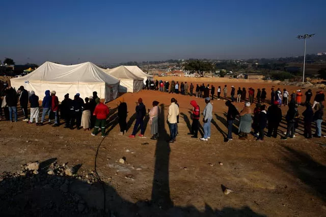 Voters line up to cast their ballot for general elections in Alexandra, near Johannesburg, South Africa