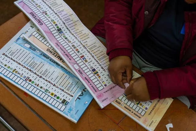 An election official prepares the ballots for the general elections in Soweto, South Africa