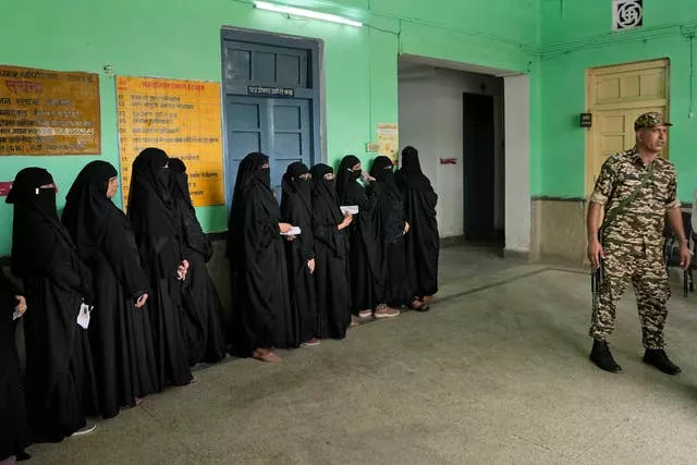 Muslim women stand in a queue to cast their votes in the seventh and final phase of national elections, in Varanasi, India