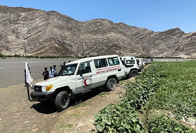 Health worker vehicles near the site of the sunken boat