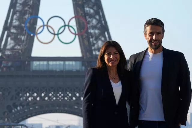 Paris mayor Anne Hidalgo with an Olympic organiser before the Eiffel Tower