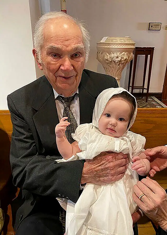 Orville Allen holding his great-granddaughter at her baptism