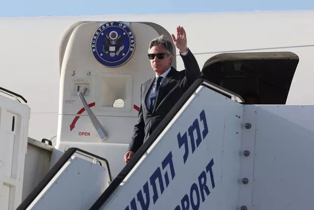Antony Blinken waves as he arrives at Ben Gurion airport near Tel Aviv 